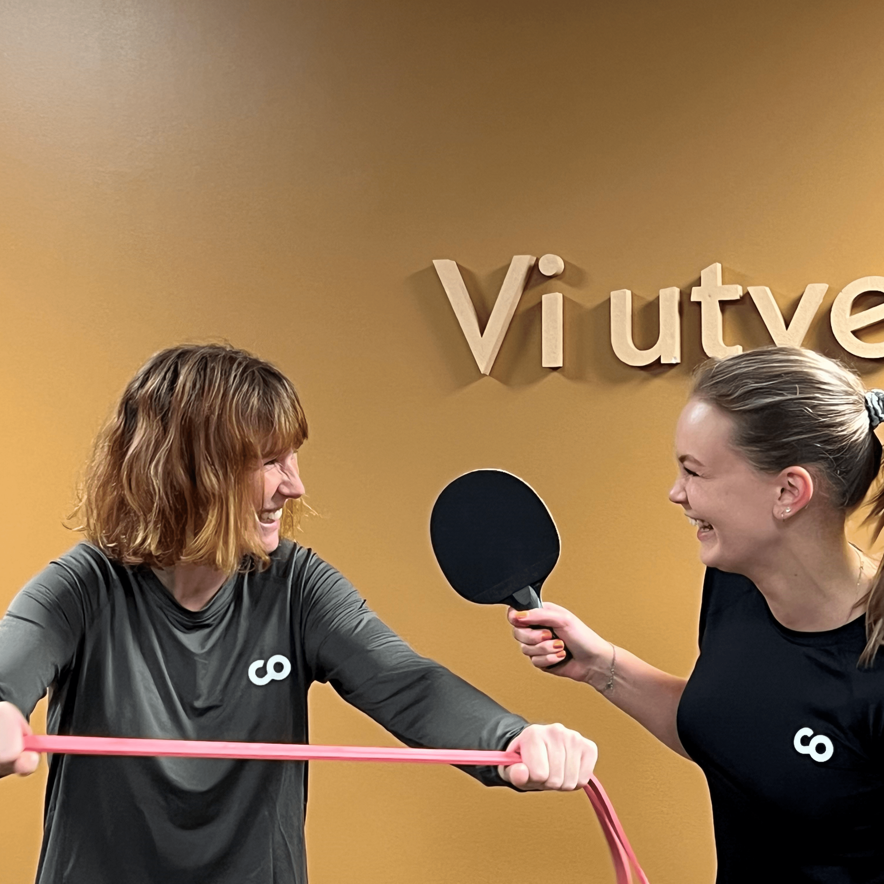 Two girls playing ping pong next to Biztalk